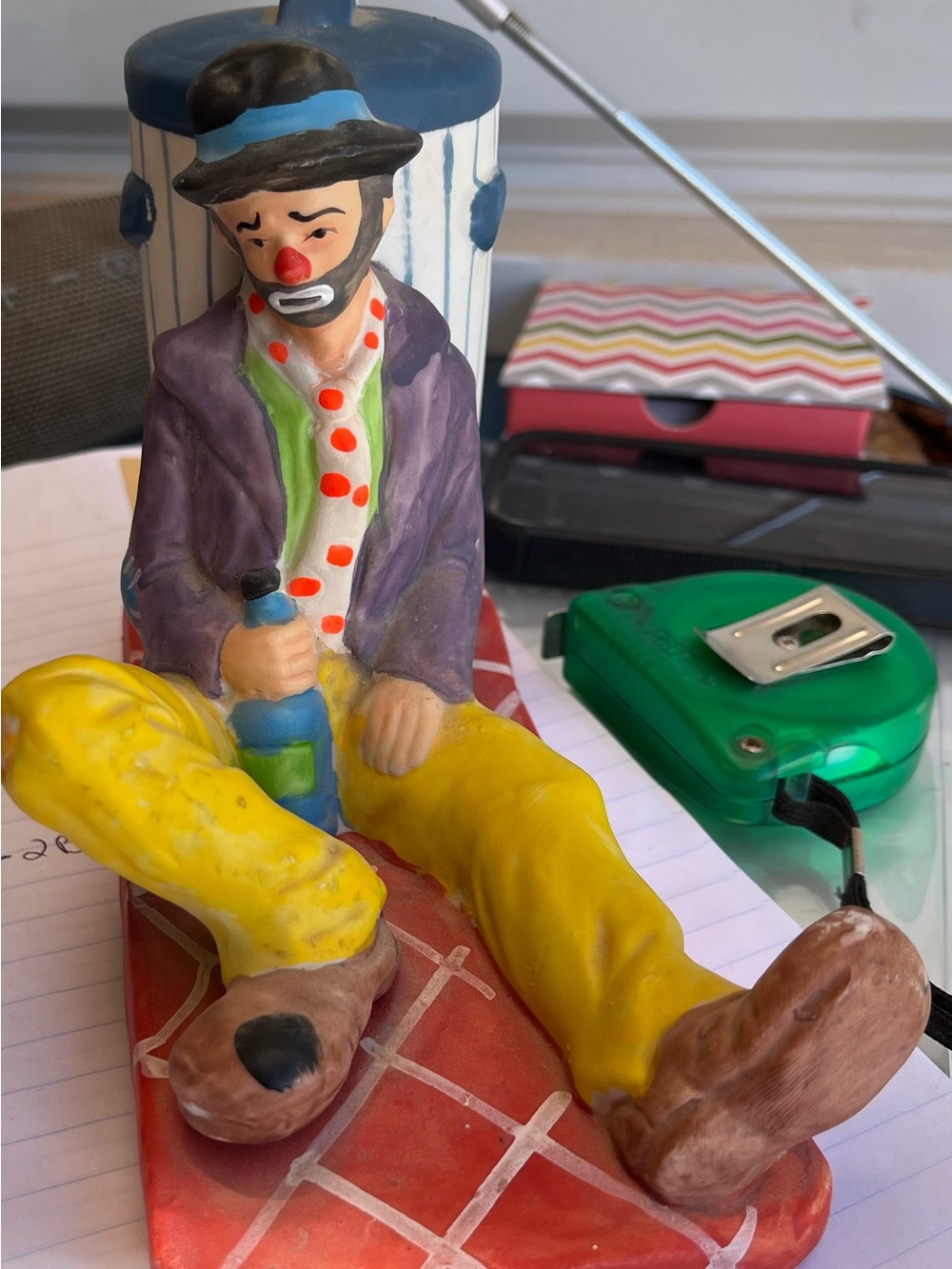 Drunken Clown sitting against a garbage can ceramic statue